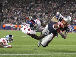 Aaron Hernandez of the New England Patriots scores a touchdown while being covered by New York Giants'  Kenny Phillips during their Nov. 6 meeting in Foxboro. Giants won. (GETTY IMAGES)