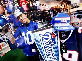 Melodie Chaing models New York Giants and New England Patriots gear at Sports Obsession in St. Catharines, Ont. (QMI AGENCY)