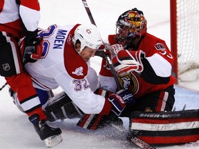 Montreal Canadiens Travis Moen (L) crashes the net. REUTERS/Chris Watti