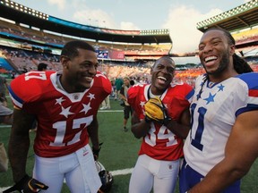 NFC wide receiver Larry Fitzgerald of the Arizona Cardinals (R) laughs with AFC wide receiver Mike Wallace (L) and kick return Antonio Brown, both of the Pittsburgh Steelers, after their NFL Pro Bowl at Aloha Stadium in Honolulu, Hawaii January 29, 2012. REUTERS/Hugh Gentry