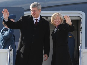 Prime minster Stephen Harper and his wife Laureen Harper wave as they board CF01 en route to China at the Ottawa International Airport on Feb. 6, 2012. (ANDRE FORGET/QMI AGENCY)