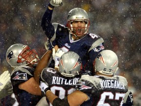 New England Patriots Adam Vinatieri celebrates atop his teammates shoulders after kicking the game-winning field goal in overtime to defeat the Oakland Raiders in their AFC divisional playoff game January 19, 2002 at Foxboro Stadium in Foxboro, Massachusetts. (REUTERS)