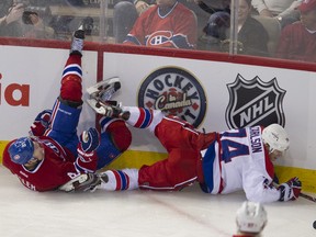 Lars Eller and John Carlson fall to the ice in the second period of a 3-0 shutout by the Capitals.  PIERRE-PAUL POULIN/QMI Agency