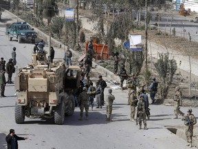 U.S. soldiers and Afghan security forces secure an area near a car bomb blast attack in the city of Kandahar Feb. 5, 2012. REUTERS/Ahmad Nadeem