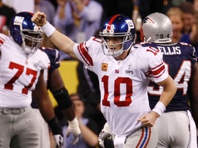 New York Giants quarterback Eli Manning celebrates his first quarter touchdown pass against the New England Patriots in Sunday's Super Bowl. (REUTERS)