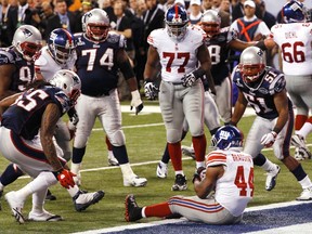 New York Giants running back Ahmad Bradshaw sits down in the end zone to score the game winning touchdown in the fourth quarter of Super Bowl XLVI Sunday in Indianapolis. (REUTERS)
