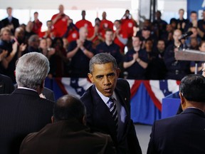 U.S. President Barack Obama shakes hands after speaking about the economy at Fire Station Number Five in Arlington, Virginia February 3, 2012.  (REUTERS/Larry Downing)