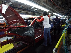 Workers assemble a pre-production 2013 Dodge Dart during a tour of the Chrysler Belvidere Assembly plant in Belvidere, III., February 2, 2012. REUTERS/Frank Polich