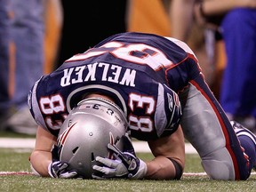 Wes Welker of the New England Patriots lays on the ground in the fourth quarter during Super Bowl XLVI at Lucas Oil Stadium on Feb. 5, 2012 in Indianapolis, Indiana.  (Elsa/Getty Images/AFP)
