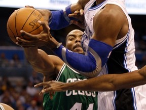 Orlando Magic centre Dwight Howard (right) goes to the rim defended by Boston Celtics forward Chris Wilcox during a game last month. Howard is likely to be traded to a contender soon. (REUTERS)