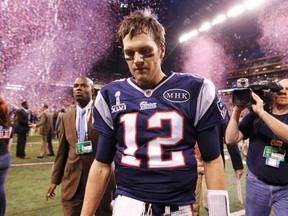 New England Patriots QB Tom Brady walks off the field after the New York Giants won Super Bowl XLVI, 21-17. (REUTERS)