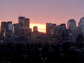 Calgary's downtown skyline is backlit by the rising sun. LYLE ASPINALL/QMI AGENCY