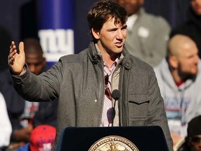 Giants quarterback Eli Manning speaks on stage as the team is honoured at City Hall Plaza following a ticker-tape parade in Manhattan on Tuesday, Feb. 7, 2012. (Spencer Platt/Getty Images/AFP)