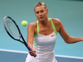 Maria Sharapova hits a return to Chanelle Scheepers at Pierre de Coubertin stadium in Paris, France, Feb. 8, 2012. (JACQUES DEMARTHON/AFP)