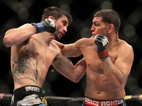 Carlos Condit (left) wins a controversial unanimous decision over Nick Diaz (right) at UFC 143 in Las Vegas. (GETTY IMAGES)