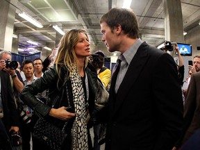 New England Patriots' QB Tom Brady speaks to his wife, super-model  Gisele Bundchen after losing to the New York Giants in Sunday's Super Bowl. (REUTERS)