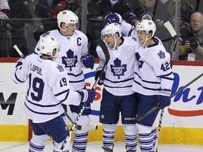 Toronto Maple Leafs forward Phil Kessel (second right) celebrates his second-period goal against the Winnipeg Jets Tuesday. Unfortunately, no one remembered to save Kessel the puck. (QMI AGENCY)
