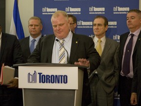 Mayor Rob Ford, flanked by councillors who support him, addresses the media following the defeat of his transit plan Thursday night. (JACK BOLAND/Toronto Sun)