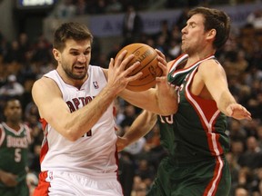 Raptors' Linas Kleiza collides with Beno Udrih of the Milwaukee Bucks during Wednesday night's game at the ACC. (Stan Behal, Toronto Sun)