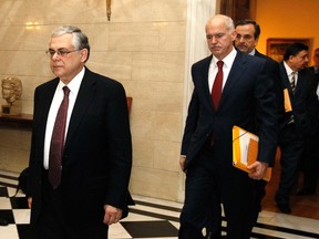 Greece's Prime Minister Lucas Papademos (L) escorts Socialist leader George Papandreou (C), conservative party leader Antonis Samaras (3rd L) and Far-right leader George Karatzaferis (2nd R) at his office in Athens February 8, 2012. (REUTERS/Yiorgos Karahalis)