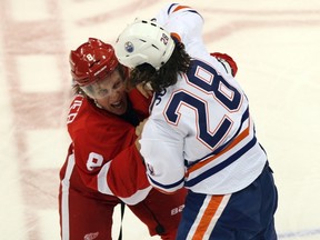 Detroit Red Wings left winger Justin Abdelkader and Edmonton Oilers left winger Ryan Jones fight each other during the first period of the Oilers 4-2 loss in Detroit on Wednesday.