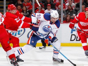 Magnus Paajarvi tries to get a shot off past Brad Stuart of the Detroit Red Wings at Joe Louis Arena on Wednesday in Detroit. Detroit won the game 4-2.