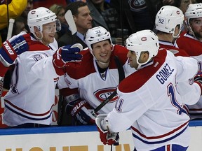 Canadiens forward Scott Gomez is congratulated by teammates after scoring against the Islanders at Nassau Coliseum in Uniondale, N.Y., Feb. 9, 2012. (SHANNON STAPLETON/Reuters)