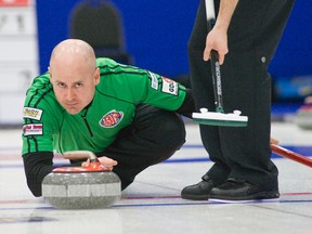 Skip Kevin Koe delivers a rock during Thursday A Event final against Kevin Martin's rink at the BP Cup in Camrose. Koe won 6-5 to end Martin's 22-game winning streak at the provincial championship.