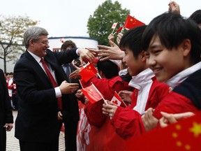 Canada's Prime Minister Stephen Harper greets students at the Huamei Bond International School in Guangzhou Feb. 10, 2012. (REUTERS/Chris Wattie)