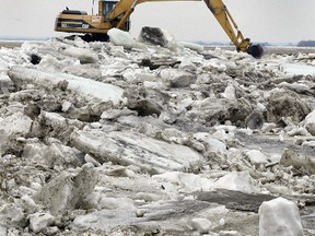A crew breaks up ice on the Tobacco Drain on PR 336 near Kane, in 2006. (BRIAN DONOGH/Winnipeg Sun)