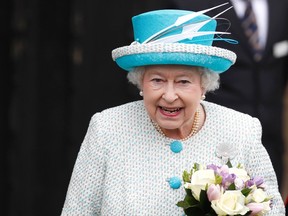 Britain's Queen Elizabeth smiles as she leaves after visiting the Town Hall in King's Lynn, in Norfolk, eastern England on February 6, 2012.  (REUTERS/Andrew Winning)