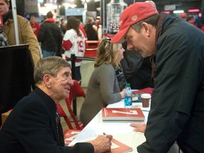 Dave McIntosh (right) speaks with legendary Red Wing Ted Lindsay in the concourse of Joe Louis Arena prior to the start of the Wings game against the Edmonton Oilers in Detroit on Wednesday, Feb. 8, 2012. (Derek Ruttan/QMI Agency)
