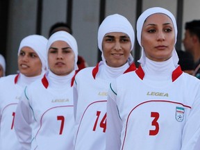 The Iranian women's national soccer team walk to the pitch before withdrawing from their qualifying match against Jordan for the 2012 London Olympic Games in Amman June 3, 2011. The Iranian team were banned from the match on Friday in the second round of qualifiers in protest against guidelines on their veil. (REUTERS/Ali Jarekji)
