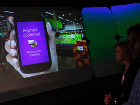 Attendees watch a demonstration of the Google wallet application during a news conference unveiling the mobile payment system in New York May 26, 2011. (REUTERS/Shannon Stapleton)