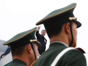 Canada's Prime Minister Stephen Harper waves while boarding his plane in Guangzhou Feb. 11, 2012. REUTERS/Chris Wattie