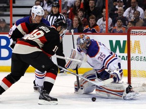 Jason Spezza looks to beat Nikolai Khabibulin while Andy Sutton looks on during the first period at Scotiabank Place in Kanata Saturday.