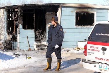 A member of the RCMP walks past a burned out trailer in Selkirk, Manitoba Saturday February 11, 2012 following an early morning fire that claimed four lives.
BRIAN DONOGH/WINNIPEG SUN/QMI AGENCY
