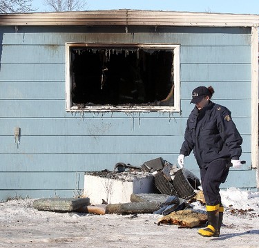 A member of the RCMP walks past a burned out trailer in Selkirk, Manitoba Saturday February 11, 2012 following an early morning fire that claimed four lives.
BRIAN DONOGH/WINNIPEG SUN/QMI AGENCY