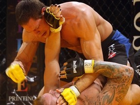 Luke Harris, top, puts the hammer down on Steve Fader, eventually winning the fight during the 2007 King of the Cage at the Corral in Calgary.