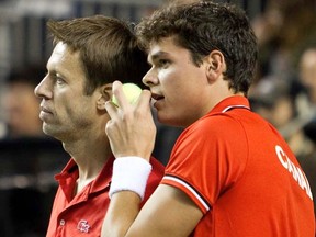 Daniel Nestor (left) and Milos Raonic talk while playing against France during their Davis Cup match in Vancouver on Saturday, Feb. 11, 2012. (REUTERS/Ben Nelms)