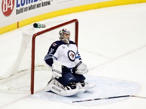 A dejected Ondrej Pavelec reacts after giving up one of eight goals in a Winnipeg Jets loss to the Pittsburgh Penguins Saturday. (JUSTIN K. ALLER/Getty Images-AFP)