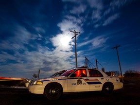 A police cruiser blocks off a rural road during the recent Mountie shootings in Killam. EDMONTON SUN/File)