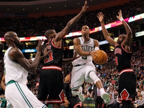 Celtics guard Rajon Rondo goes for a shot as Bulls guard Ronnie Brewer and forward Luol Deng (right) defend at TD Garden in Boston, Mass., Feb. 12, 2012. (JESSICA RINALDI/Reuters)