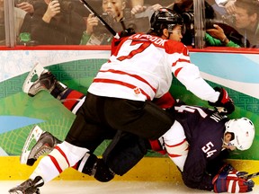 Canada's Brent Seabrook takes a moment to teach American Bobby Ryan what "the boards are" during the 2010 Olympic gold medal game.  (ANDRE FORGET/QMI AGENCY)