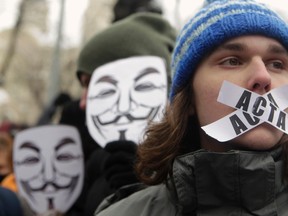 Anti-online censorship protesters wear Guy Fawkes masks in Riga, Feb. 13, 2012.  REUTERS/Ints Kalnins