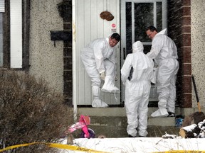 Police comb the scene of the northside April 14 killing. PERRY MAH\QMI AGENCY