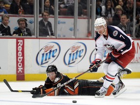 Ducks defenceman Cam Fowler falls in front of Blue Jackets forward Jeff Carter at the Honda Center in Anaheim, Calif., Feb. 3, 2012. (HARRY HOW/Getty Images/AFP)