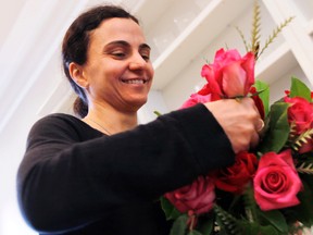 Virginia Vance, owner of Bloomfields Flowers on Bank St., busily prepares one of the hundreds of bouquets they are making for Valentine's Day, Monday, February 13, 2012.  (DARREN BROWN/QMI AGENCY)