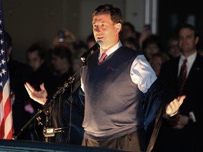 Republican presidential candidate Rick Santorum pulls off his jacket while speaking to the crowd at a campaign rally at the Washington State History Museum in Tacoma, Washington on February 13, 2012.  REUTERS/Anthony Bolante