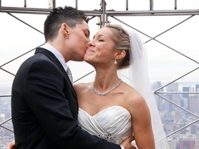 Lela McArthur (R) and Stephanie Figarelle, both from Anchorage, AK, kiss on the observation deck of the Empire State Building after being married on the 61st floor in New York, February 14, 2012. (REUTERS/Andrew Burton)
